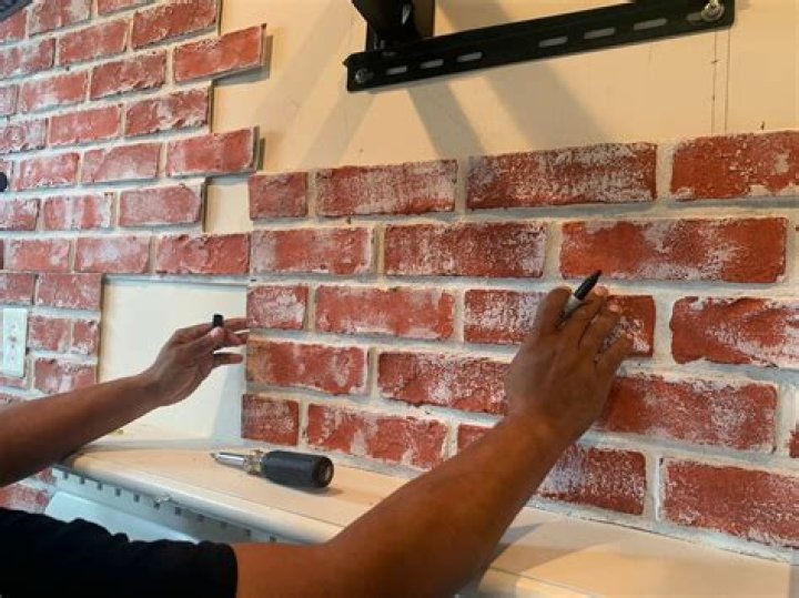 How do you install faux stone panels on brick