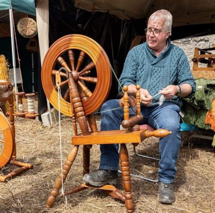 How do you spin wool into yarn on a spinning wheel?