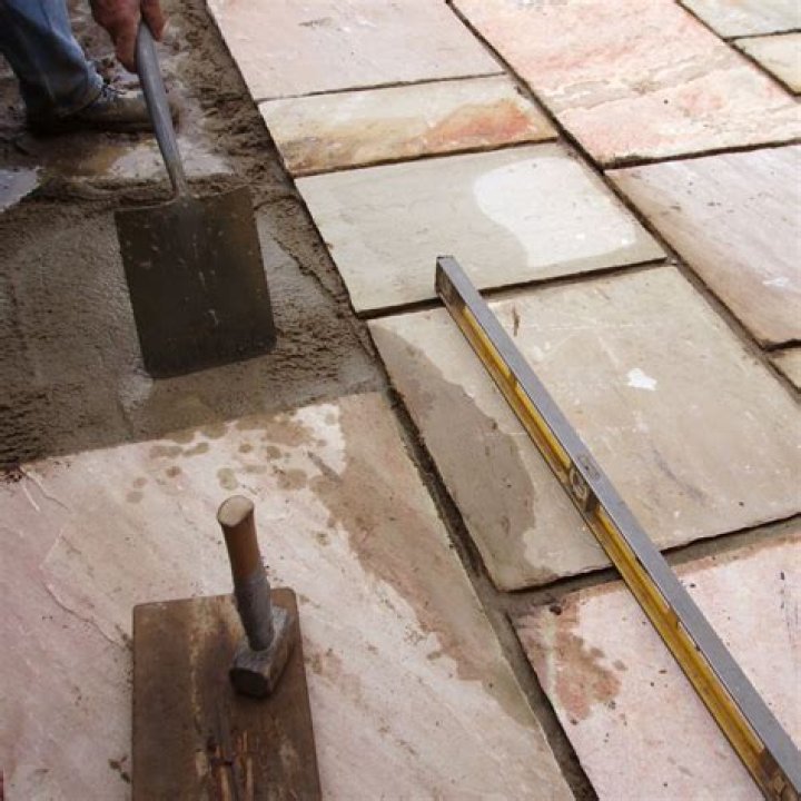 laying paving slabs on existing concrete base