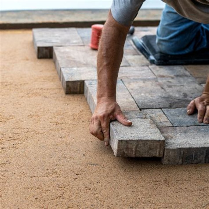 laying stone over concrete patio