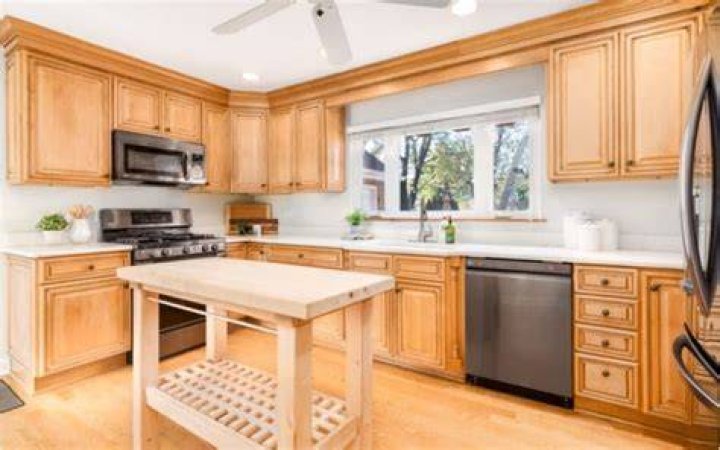light maple cabinets with white countertops