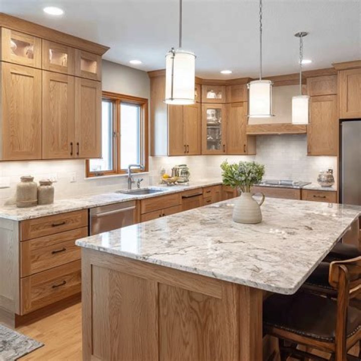 snowfall granite with oak cabinets