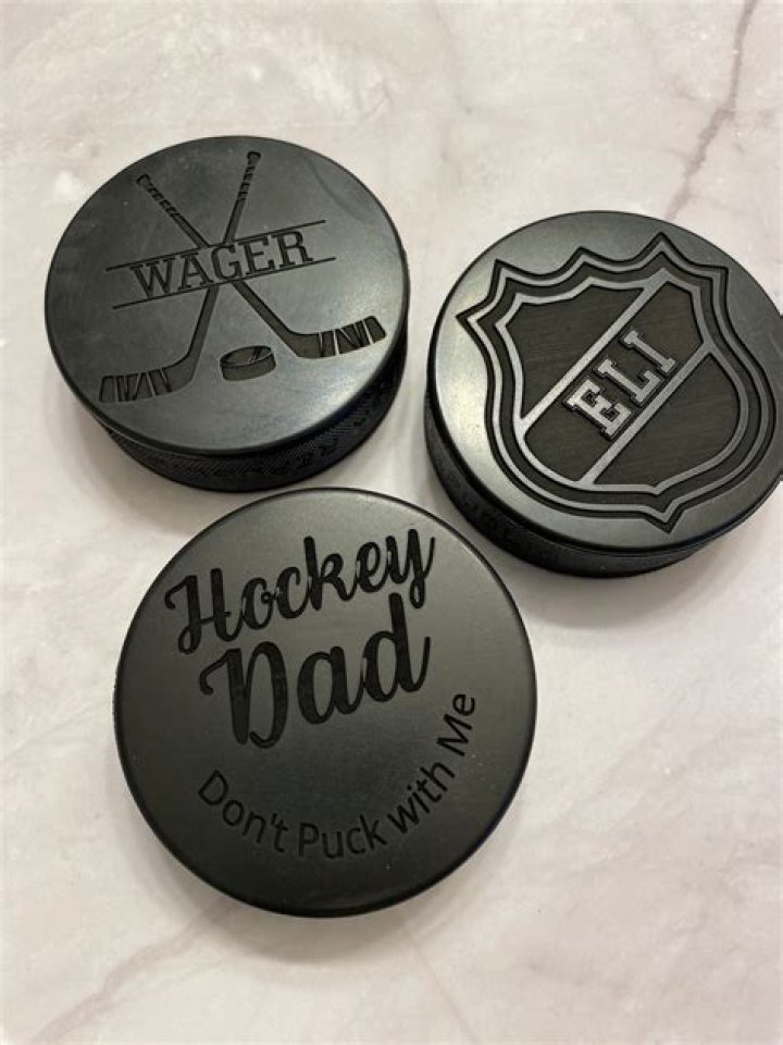 What is the puck made of in ice hockey?